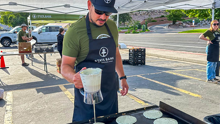 Man making pancakes at a griddle